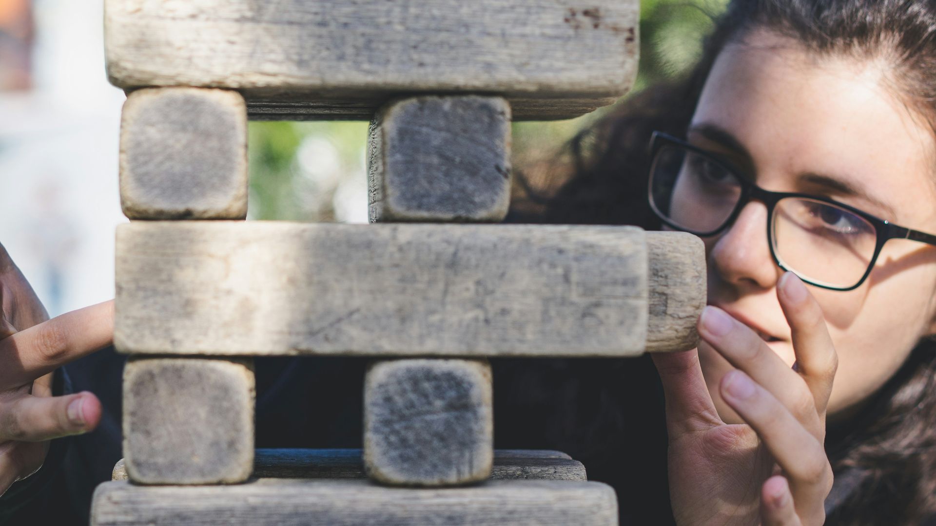 woman playing with wooden blocks