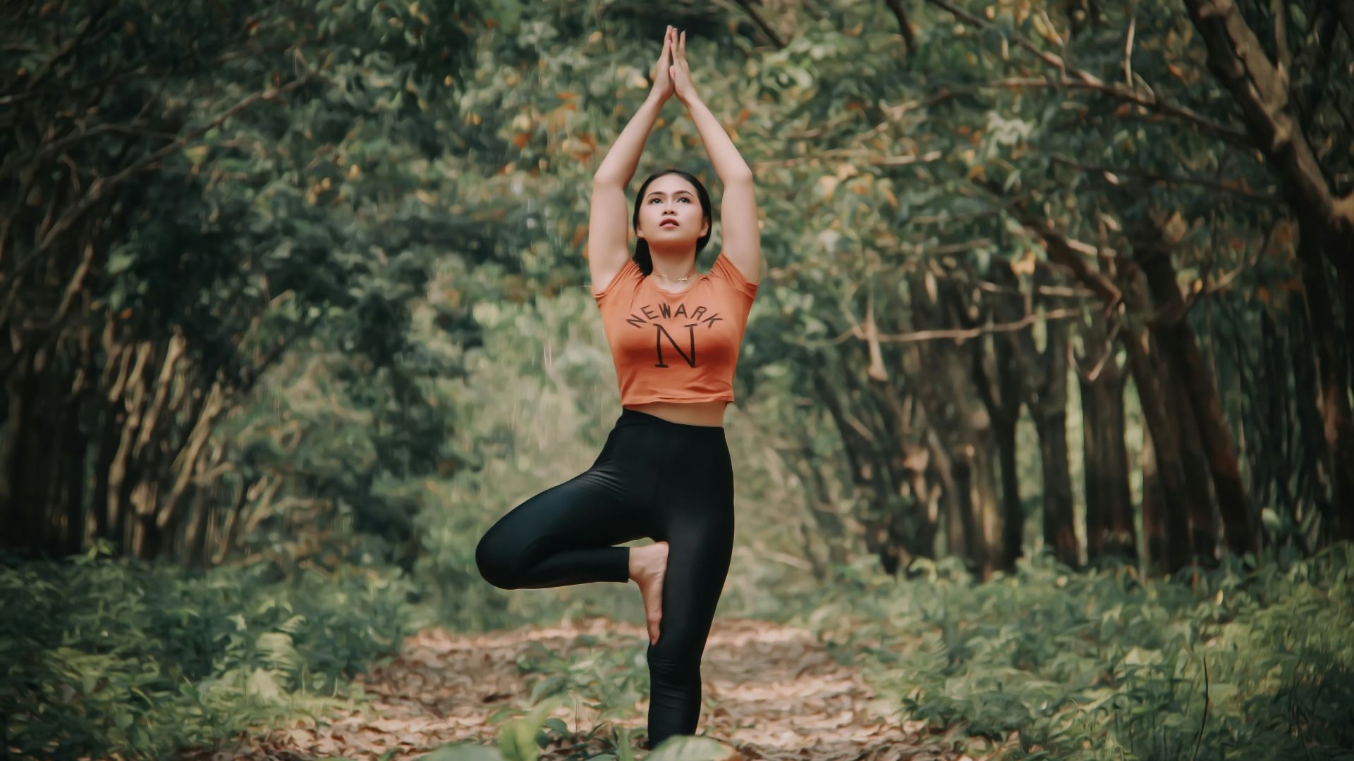 woman doing yoga near trees