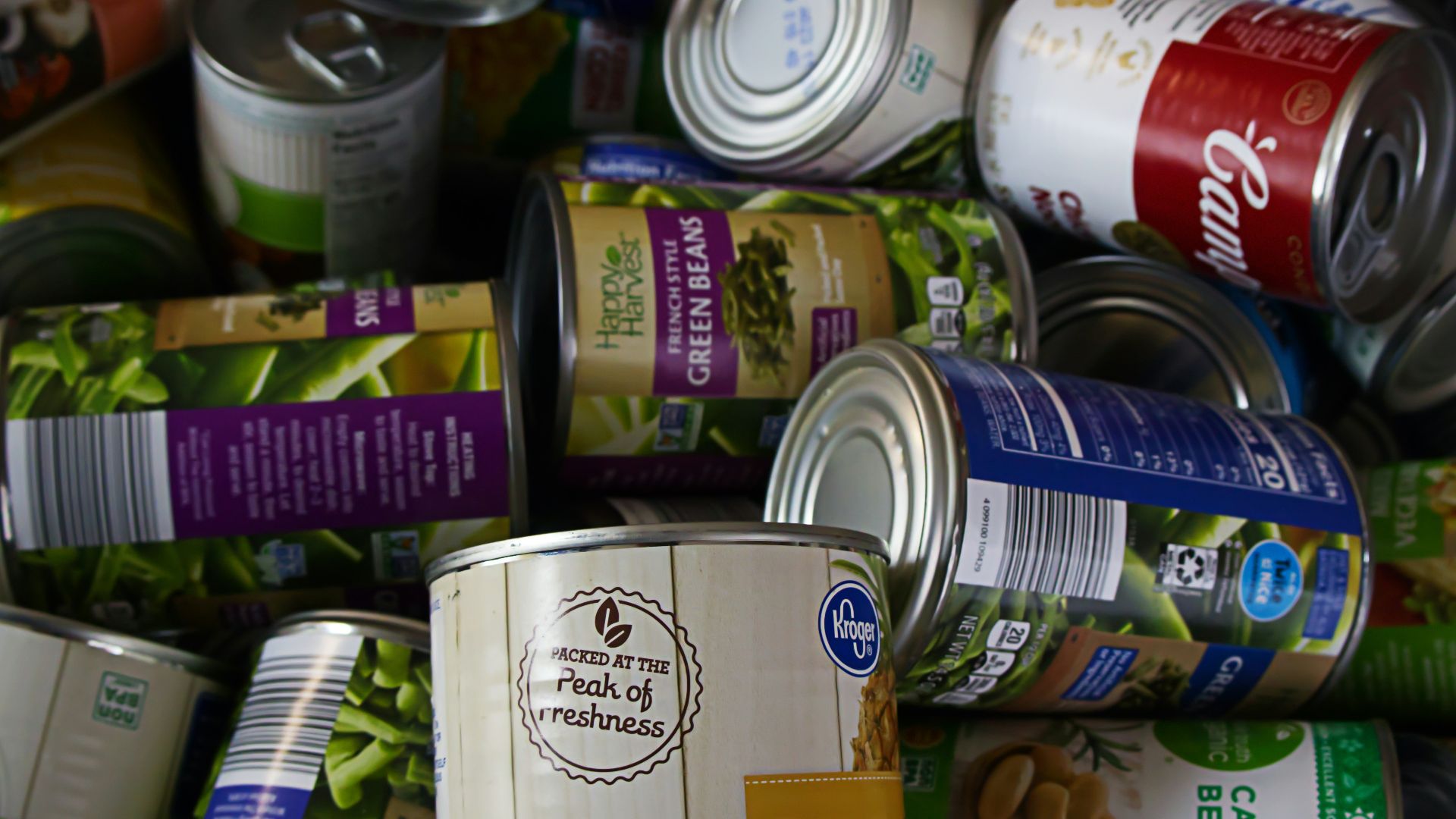 A pile of cans of food sitting next to each other