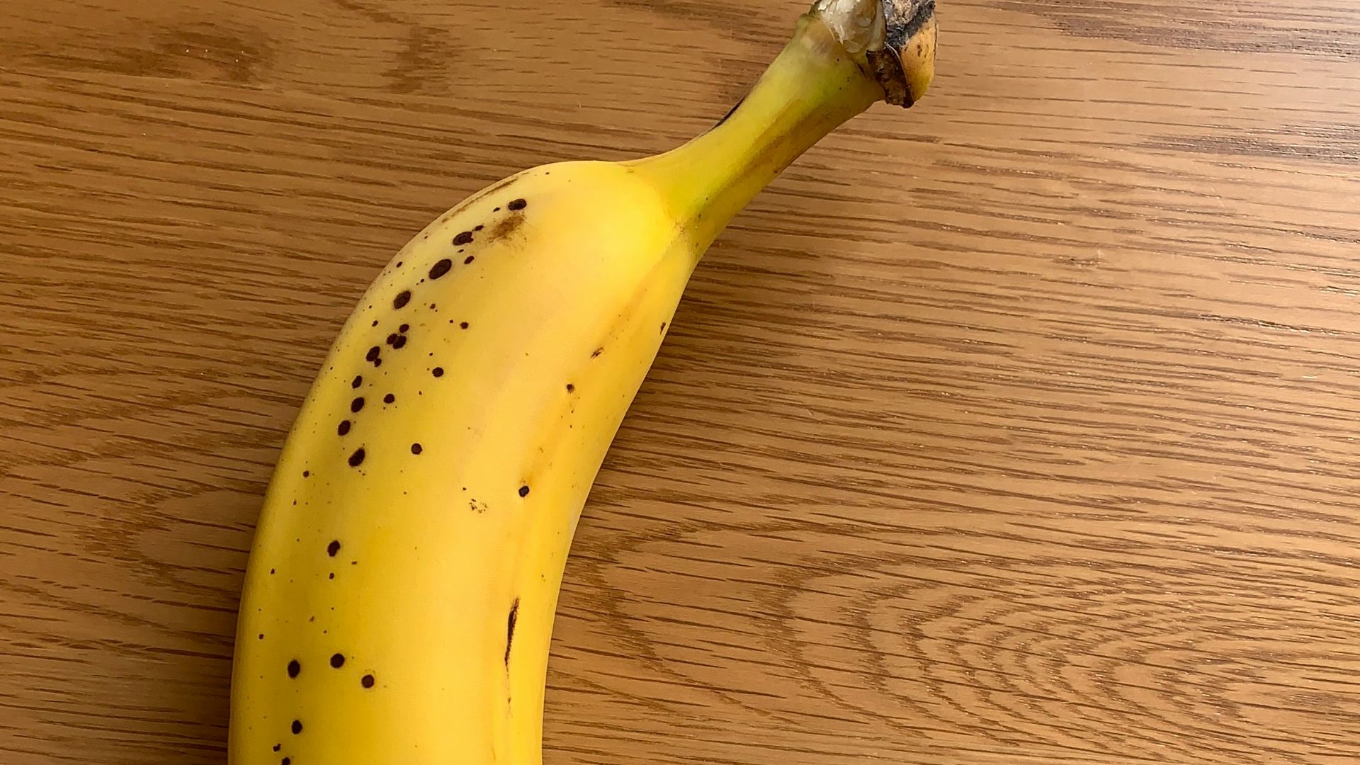 yellow banana fruit on brown wooden table