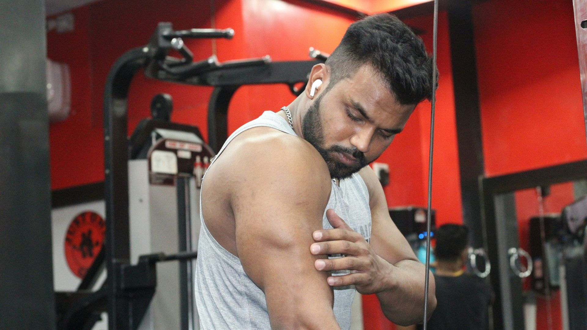 a man in a gym holding his hands together