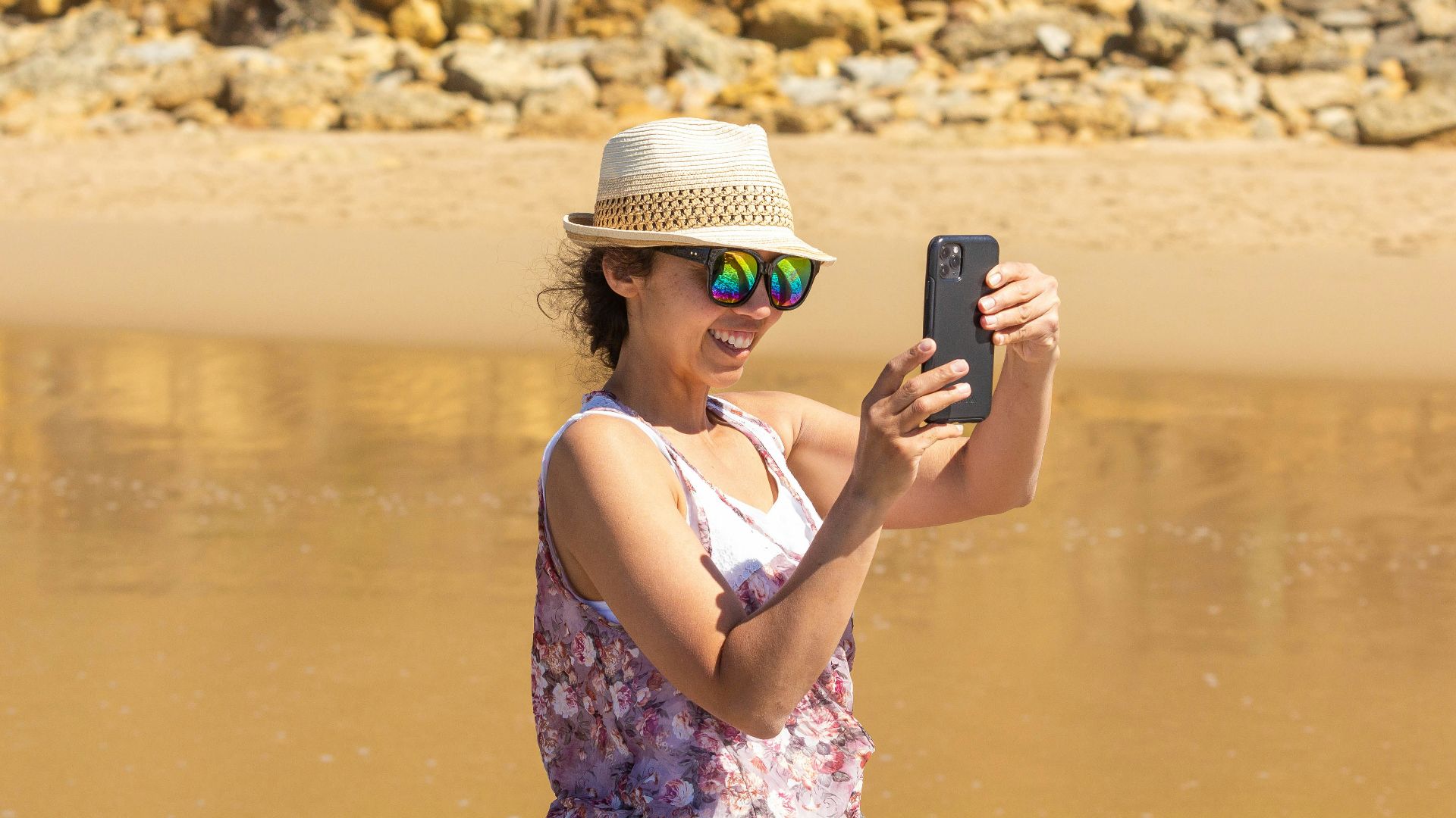 a woman taking a picture of herself in the water