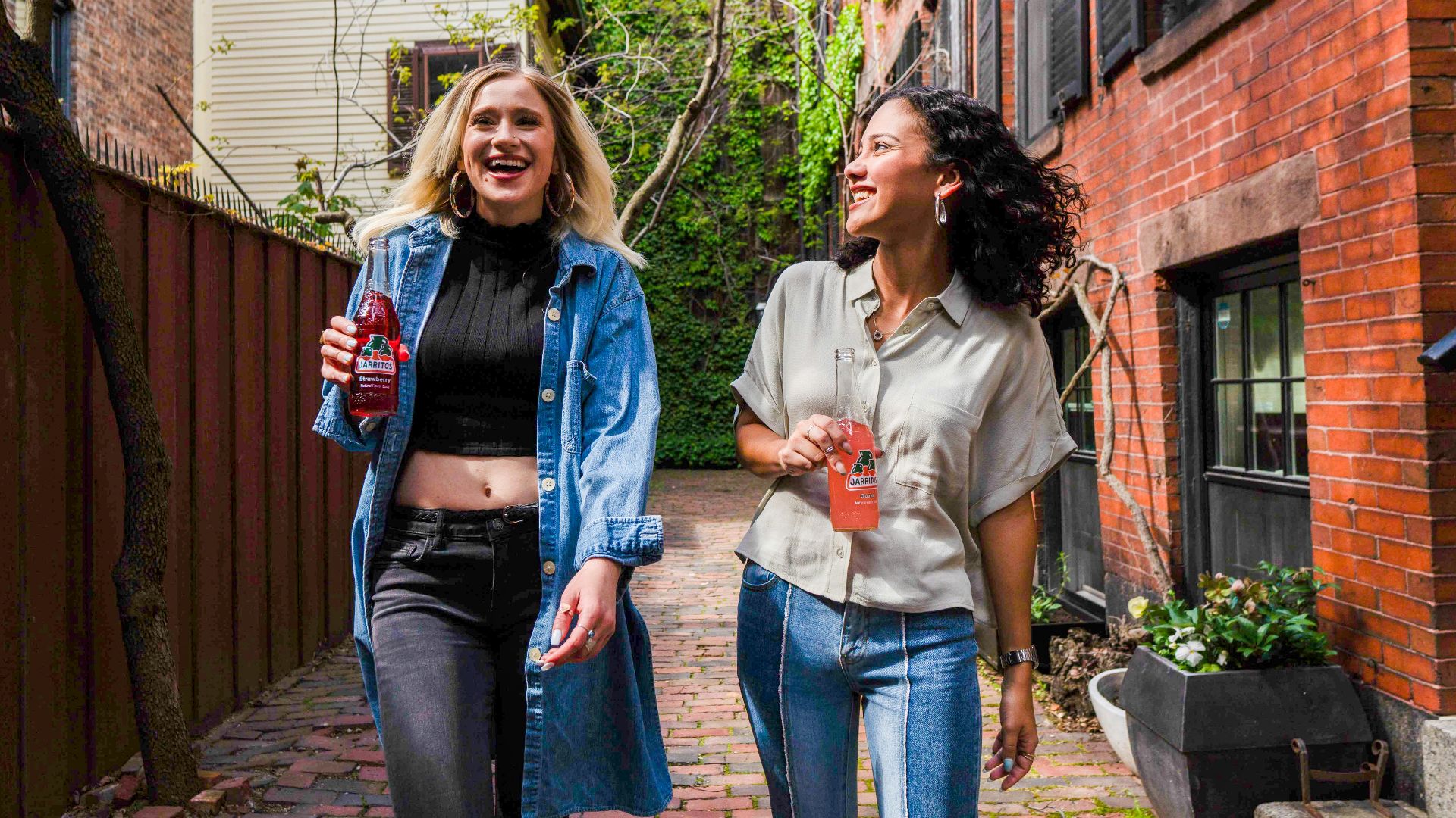 woman in blue denim jacket standing beside woman in white shirt