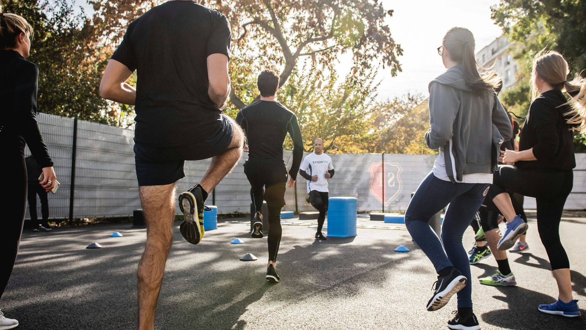 man in black t-shirt and black shorts running on road during daytime
