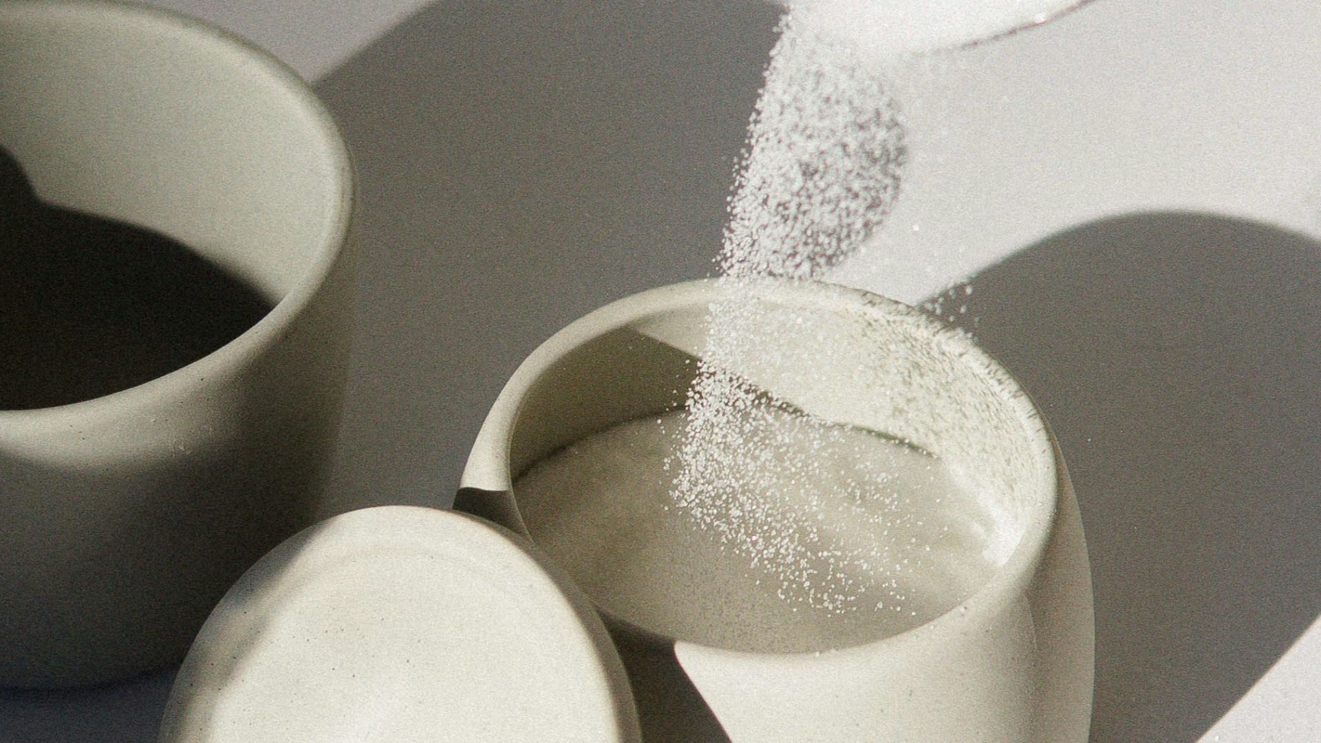 white ceramic mugs on white table