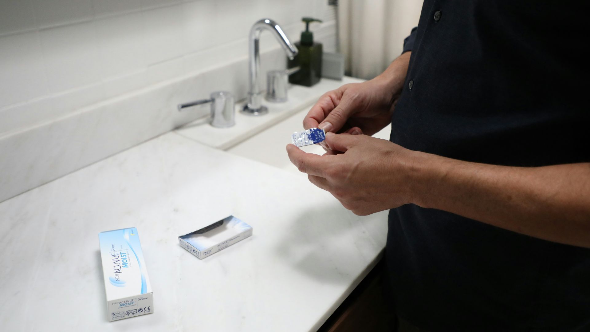 person holding blue and white plastic pack
