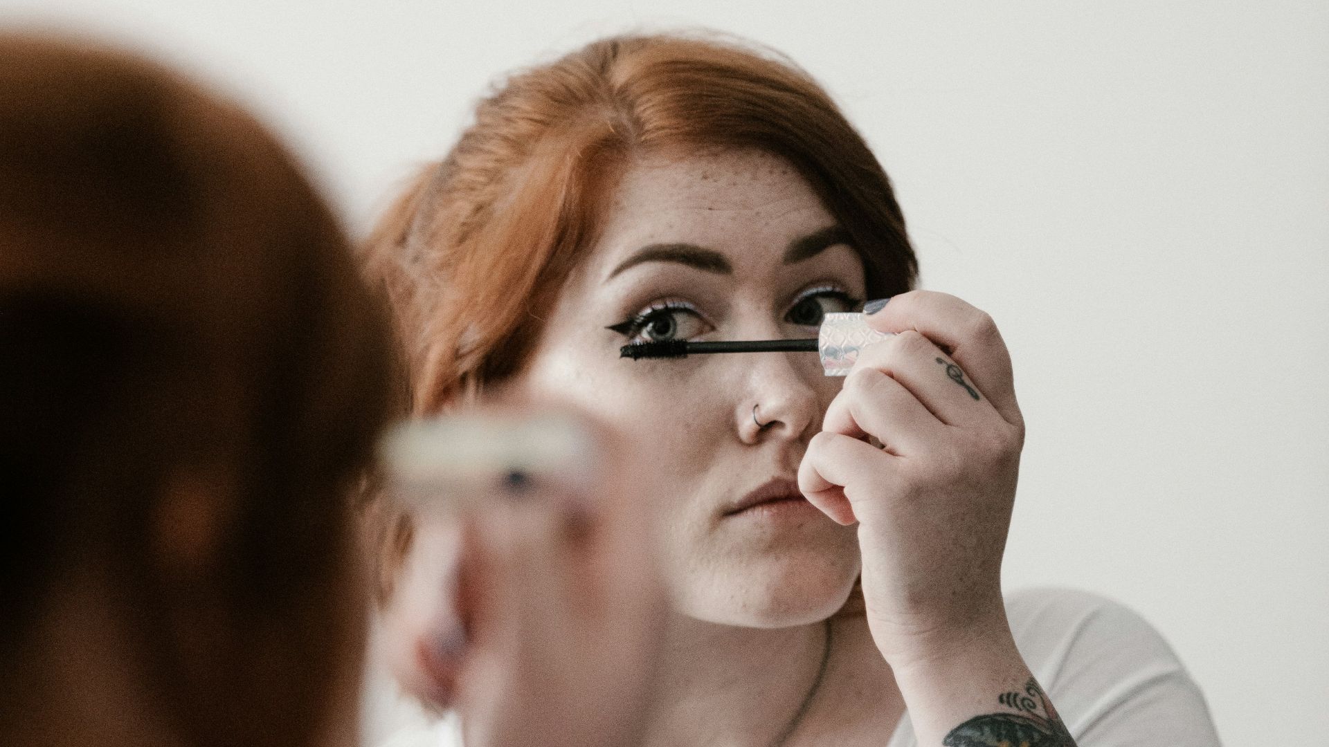 woman using makeup during daytime