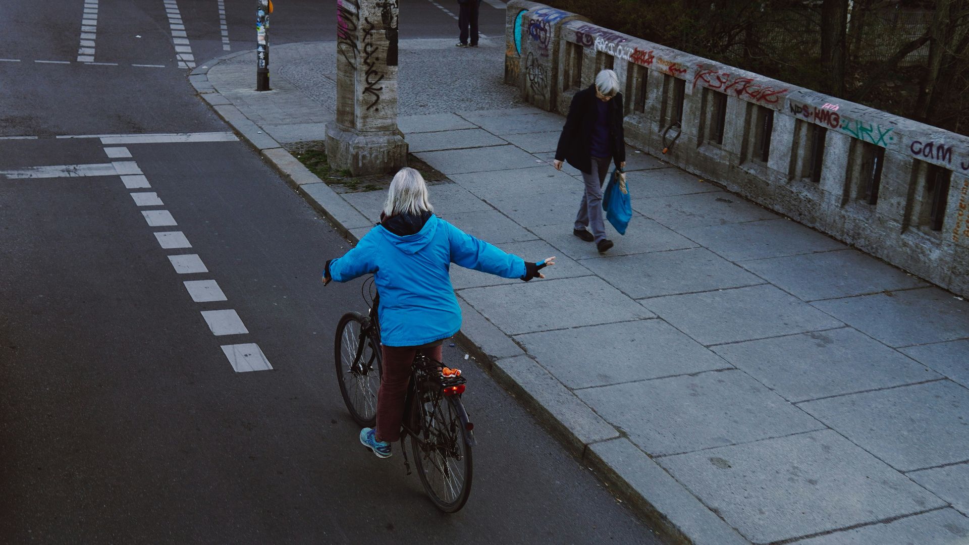 a woman riding a bike down a street