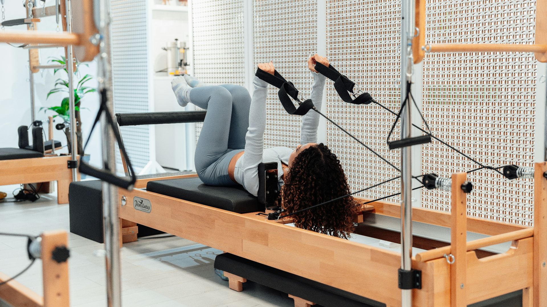 a woman is doing exercises on a rowing machine