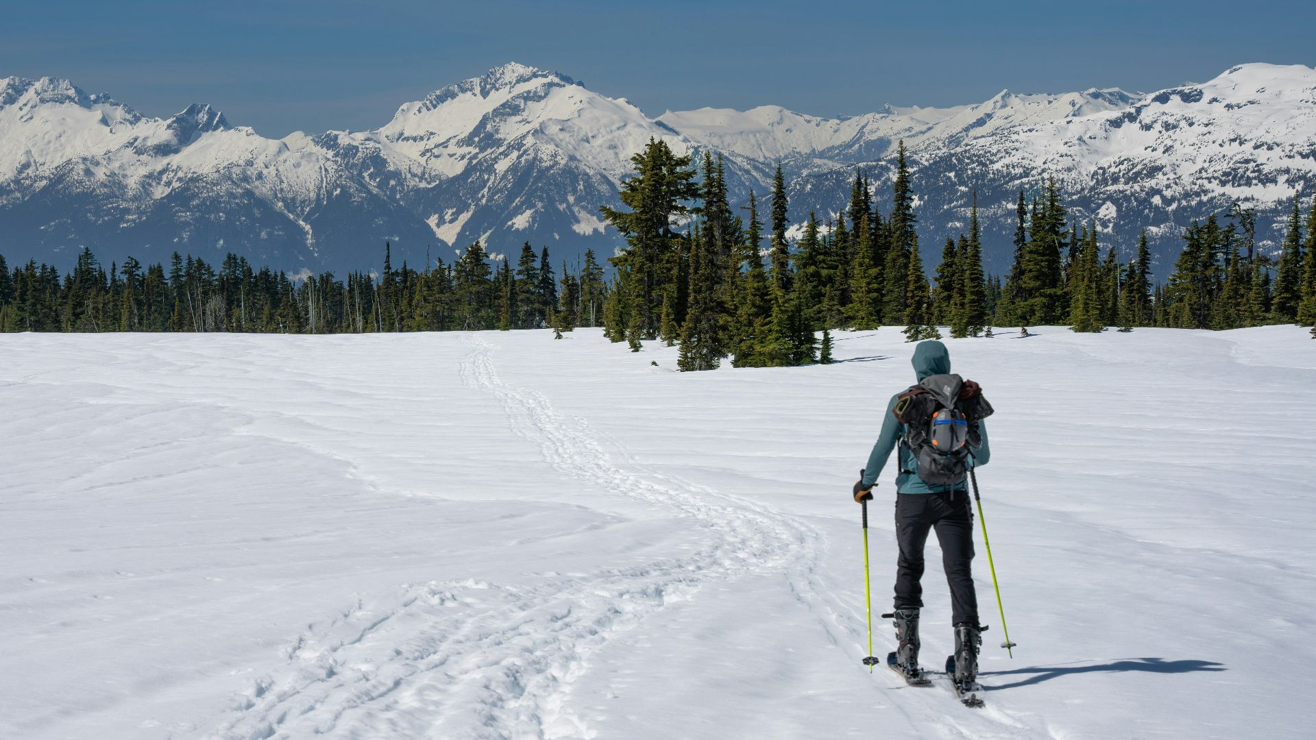 a man riding skis down a snow covered slope