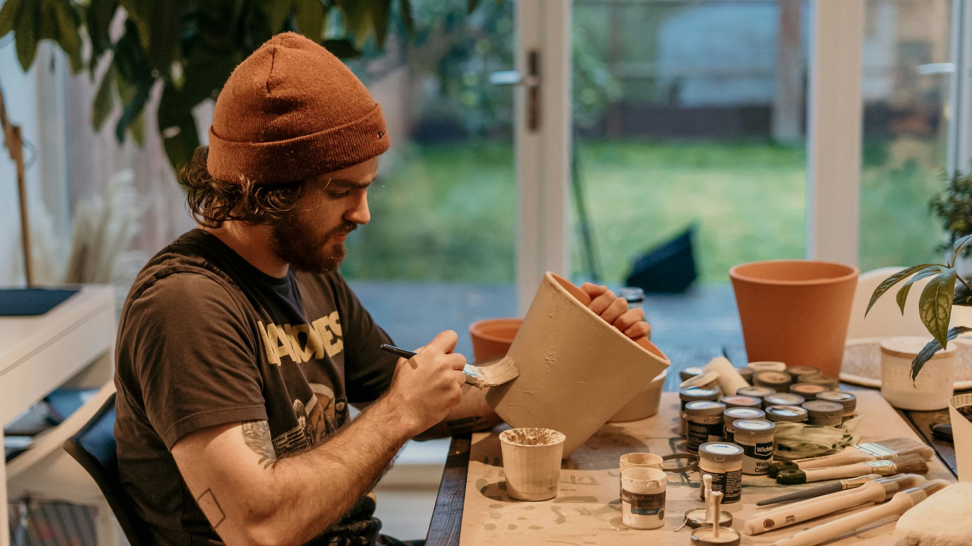 a man sitting at a table working on a project