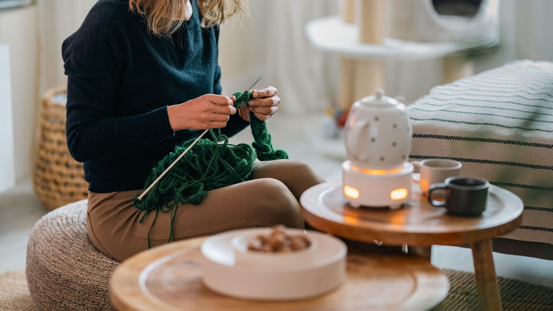 A woman sitting on a stool in a living room