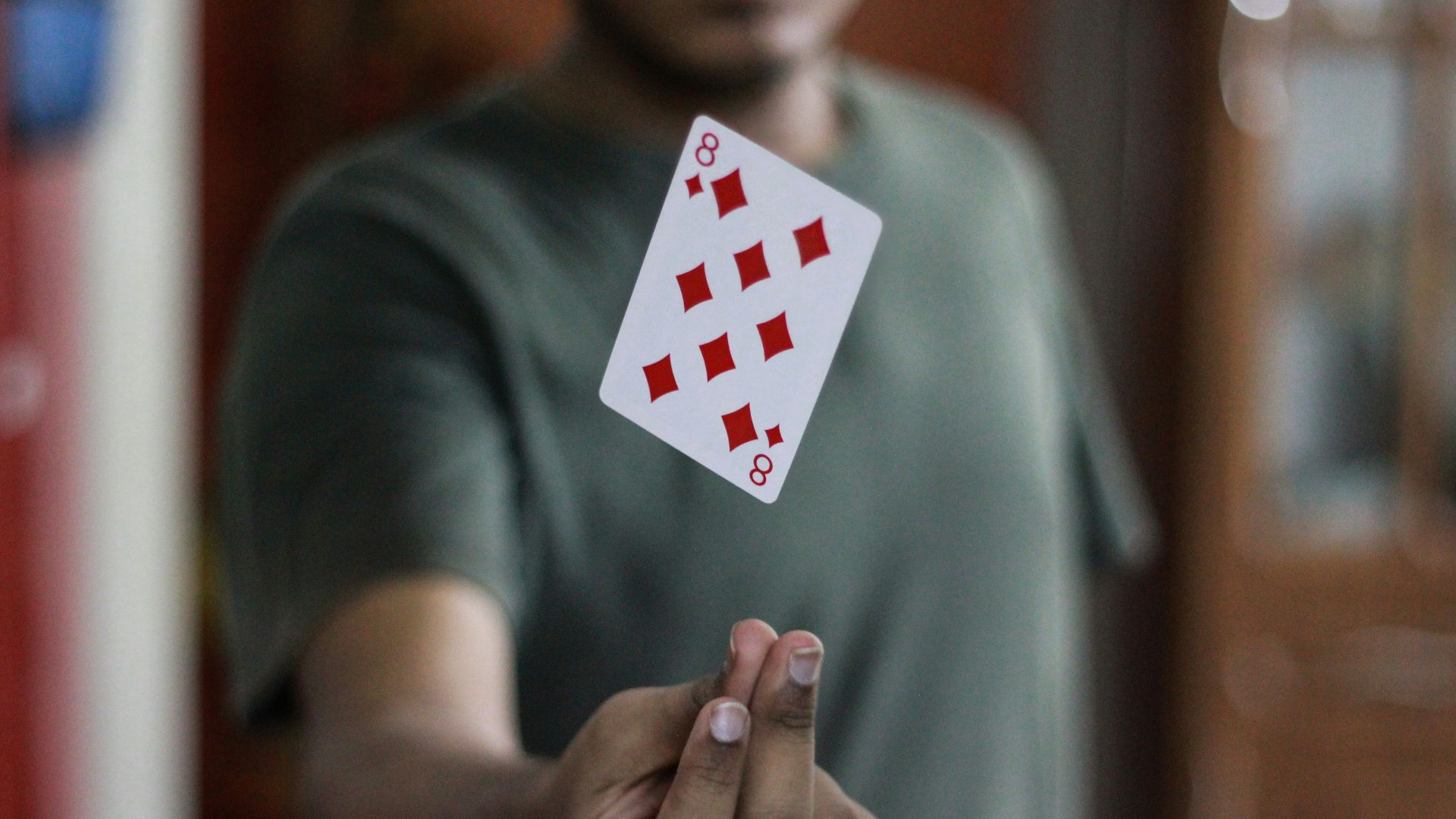 a man holding a playing card in his hand