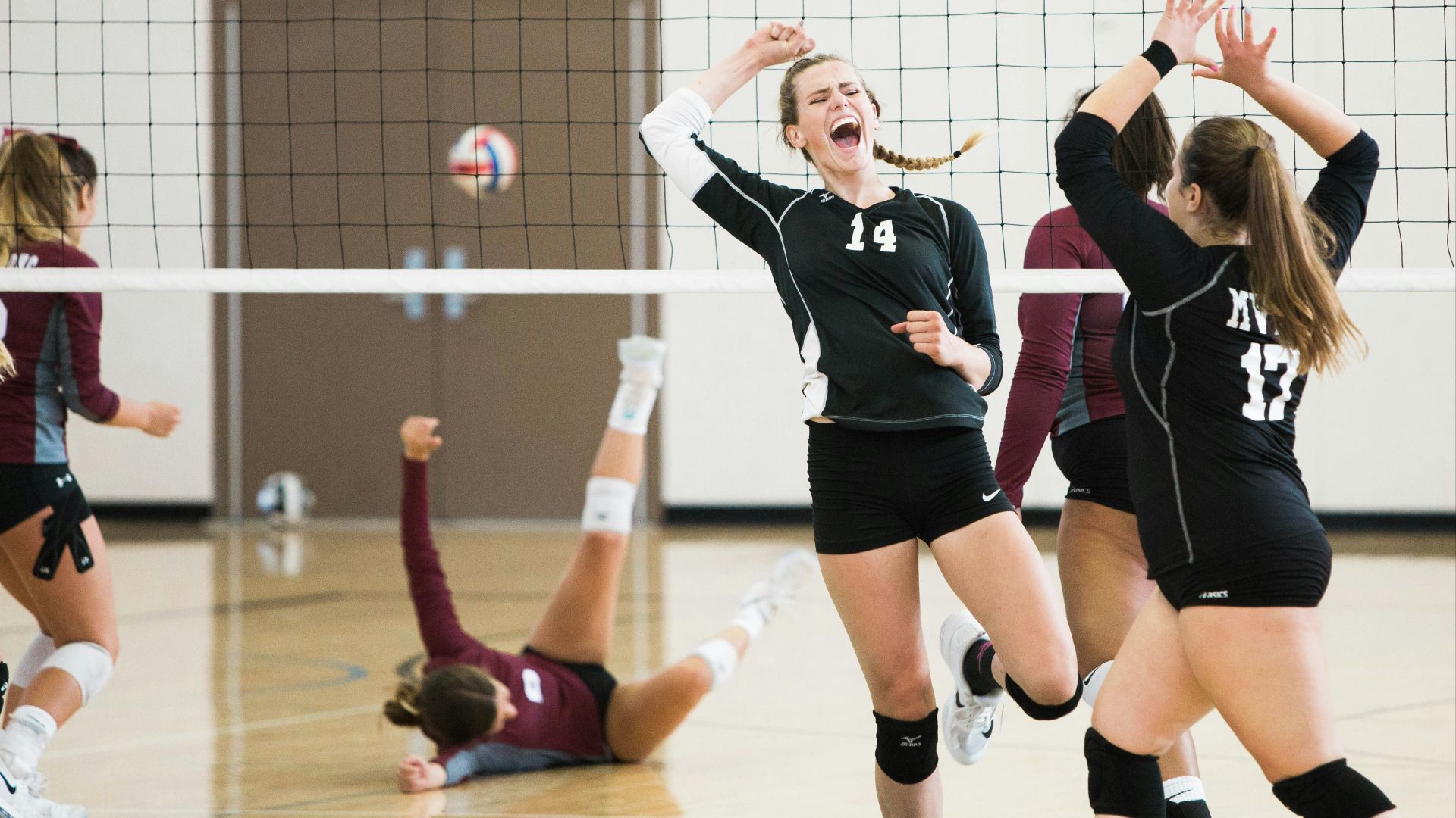 women playing volleyball inside court