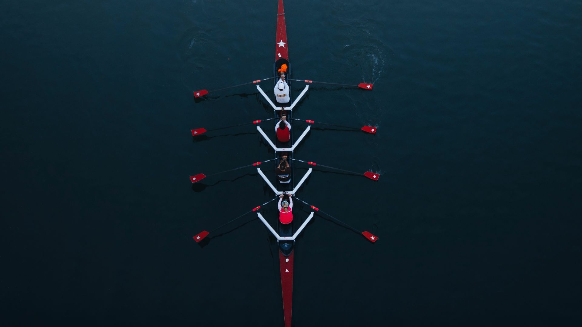 a row of boats floating on top of a body of water