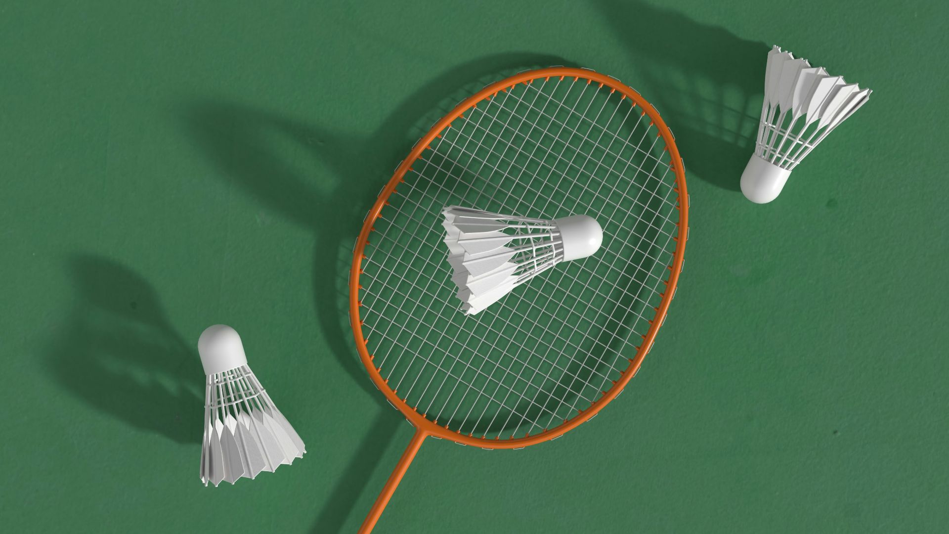 a badminton racket and two shuttles on a green surface
