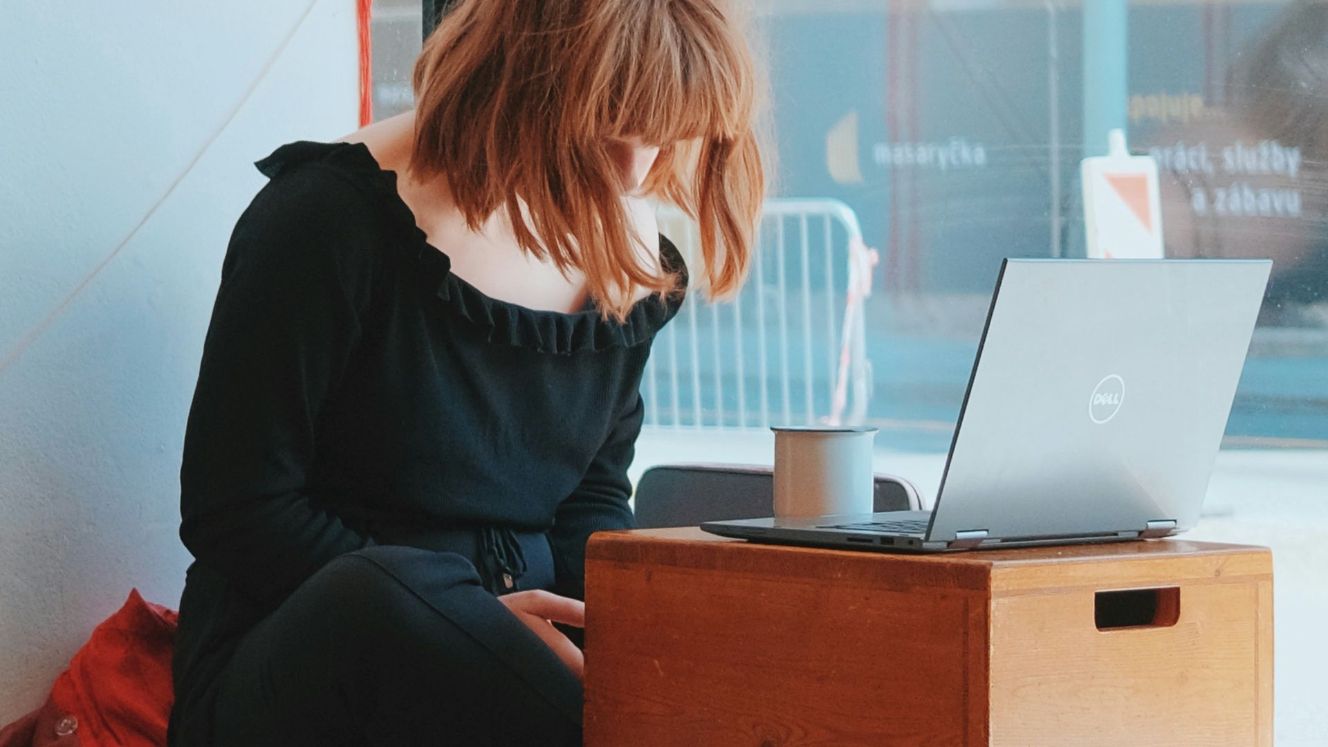 a person sitting at a desk with a laptop