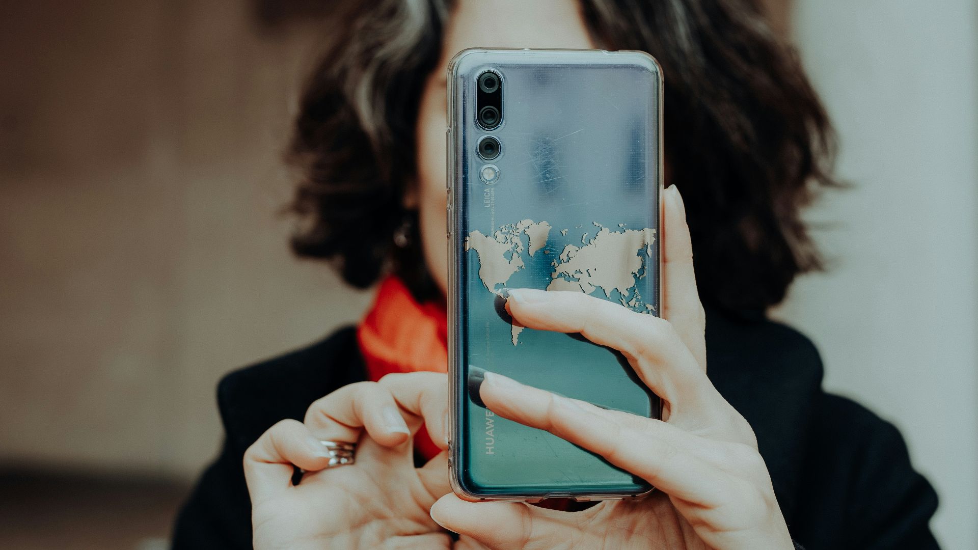 a woman holding a cell phone up to her face