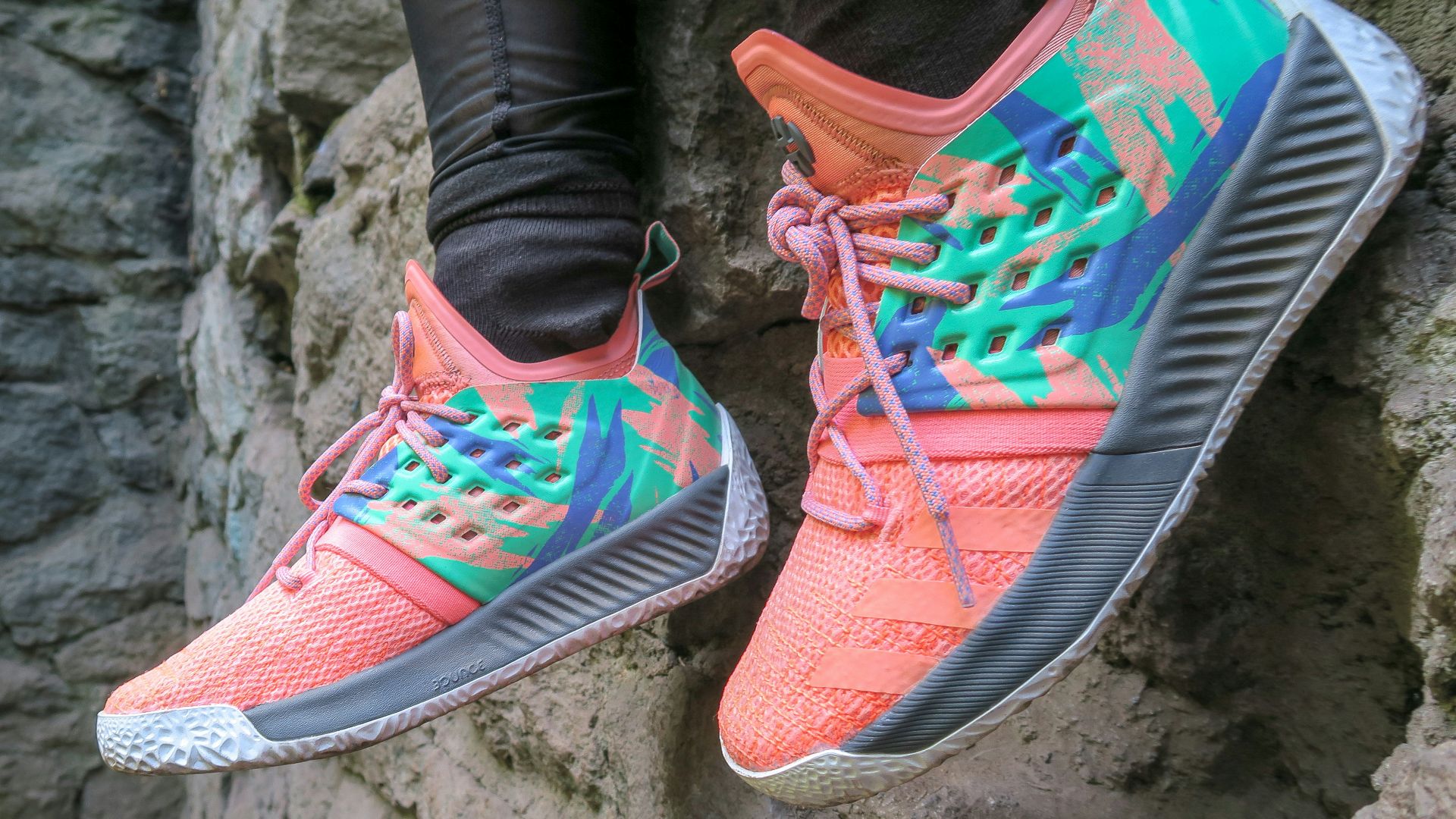 person wearing teal-and-orange adidas sneakers