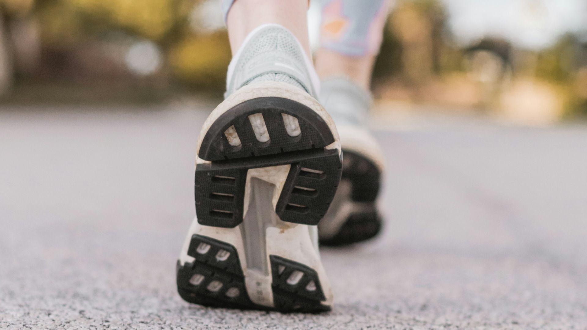 person wearing black and white nike shoes