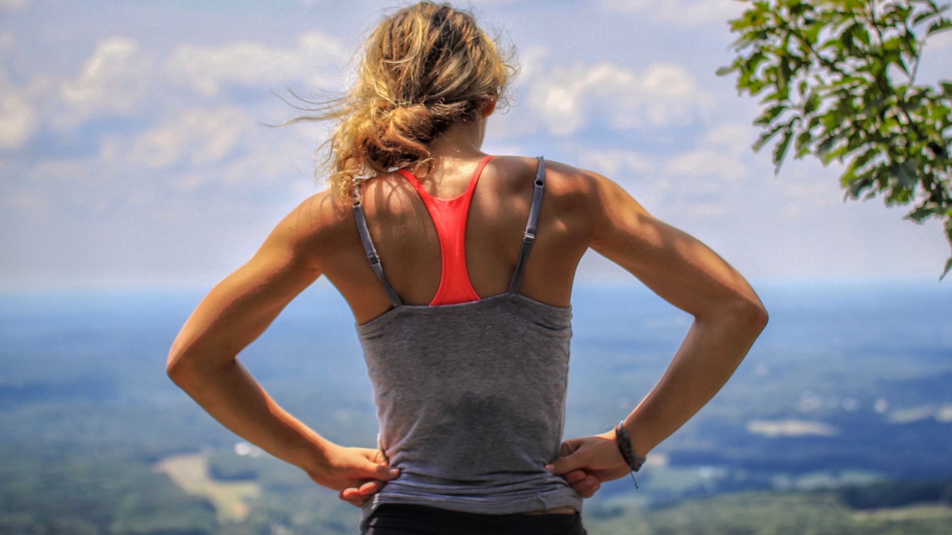 woman standing near tree looking below
