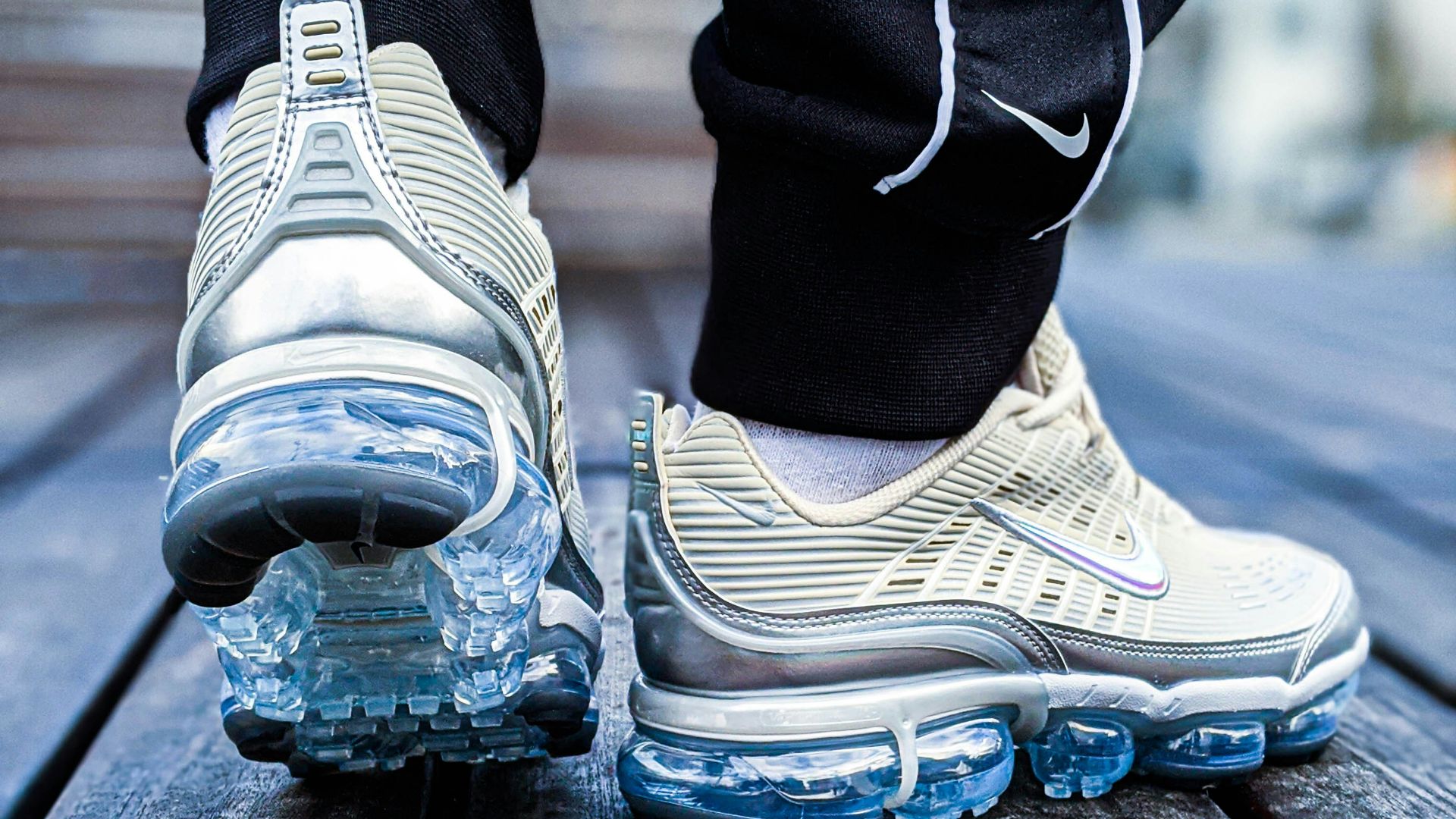 person wearing gray and white nike athletic shoes