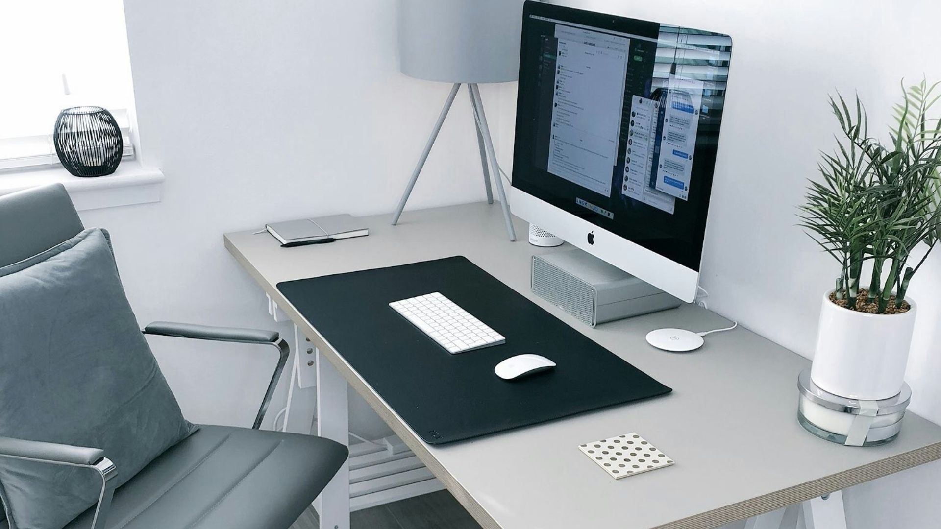 gray leather office rolling armchair beside white wooden computer desk