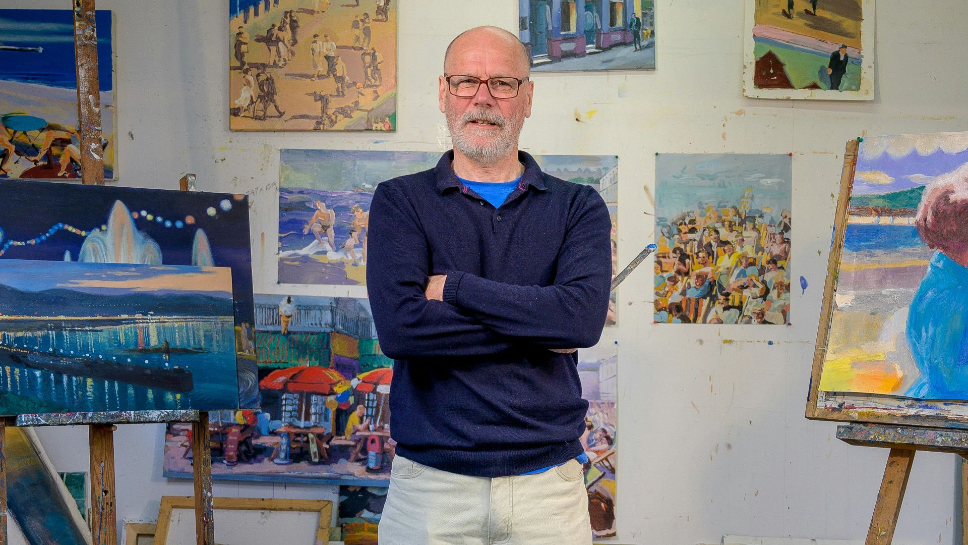 a person standing in front of a wall of paintings