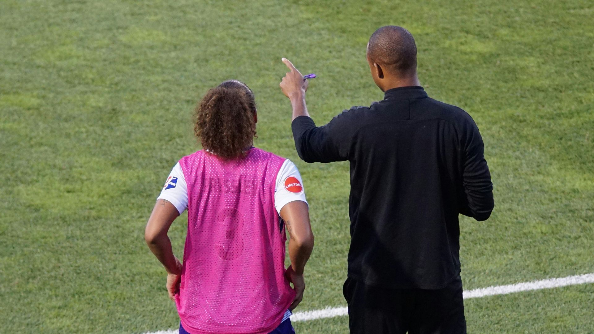 man and woman standing on field