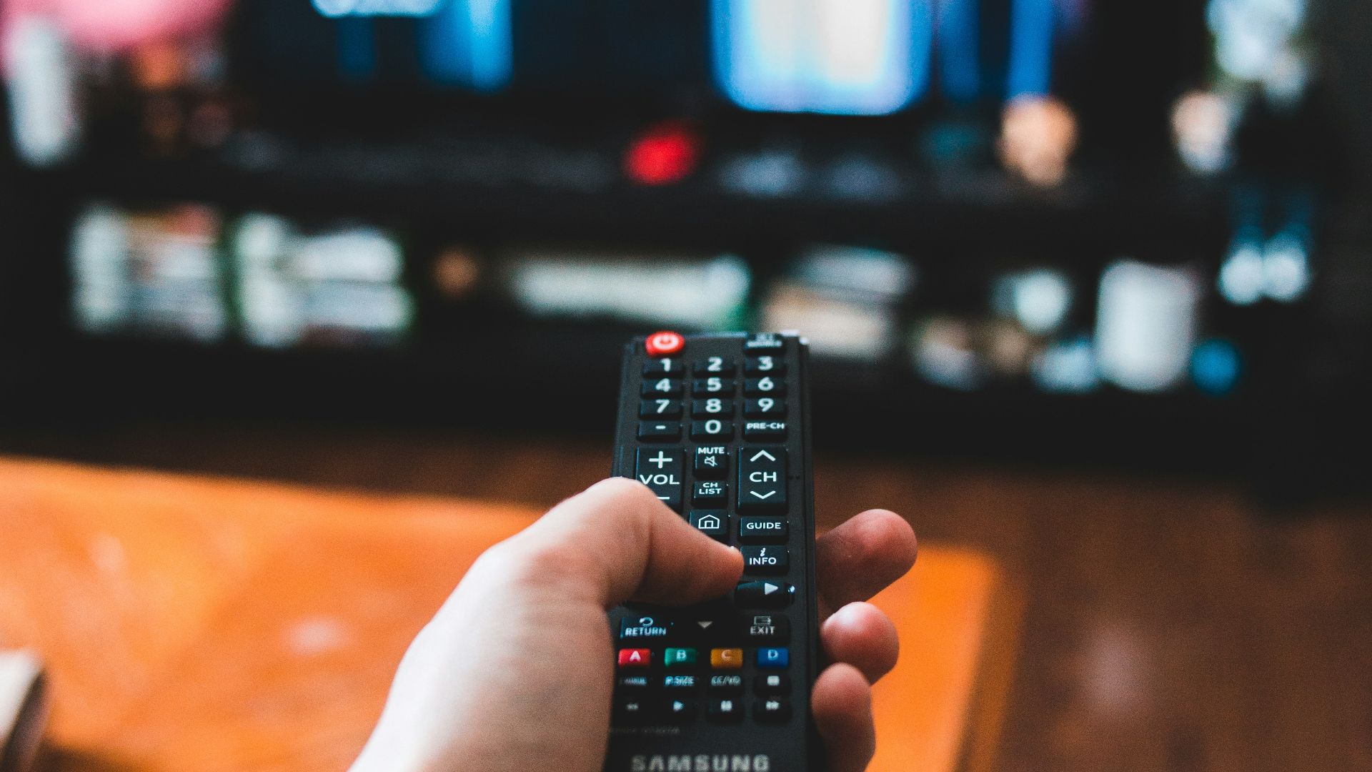 person holding black remote control