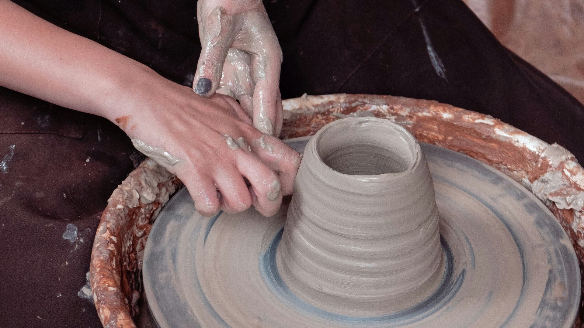 woman in black and white shirt holding white ceramic round plate