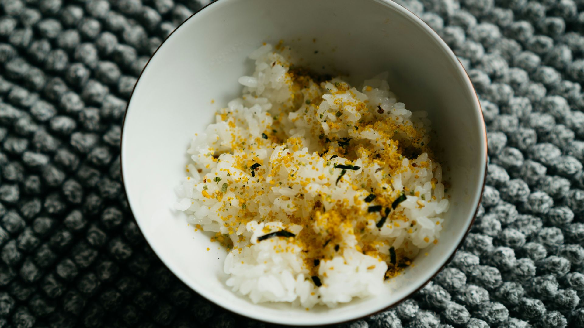 a white bowl filled with rice on top of a table
