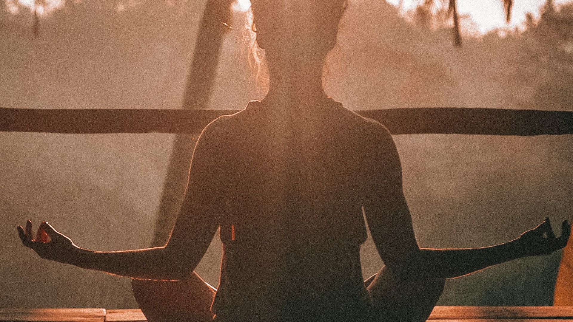 woman doing yoga meditation on brown parquet flooring