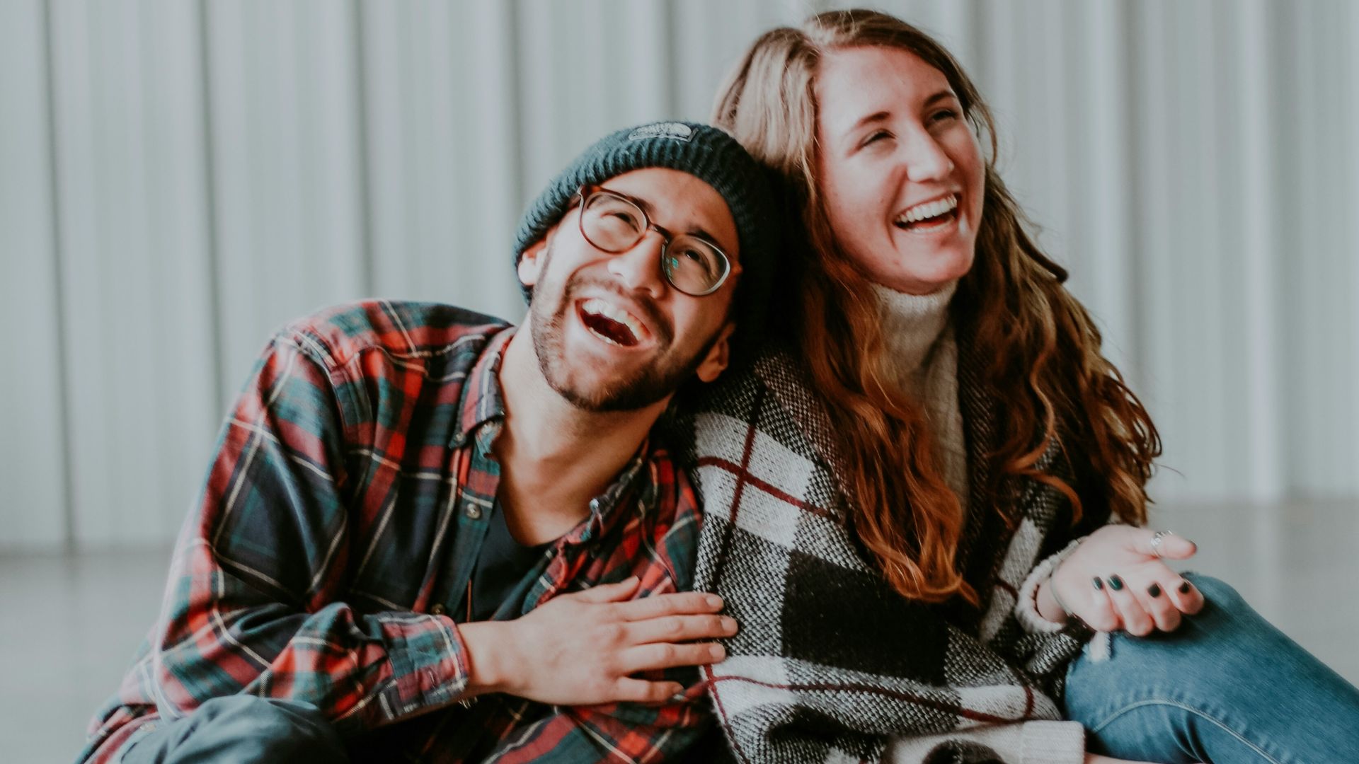 smiling woman and man sitting on floor
