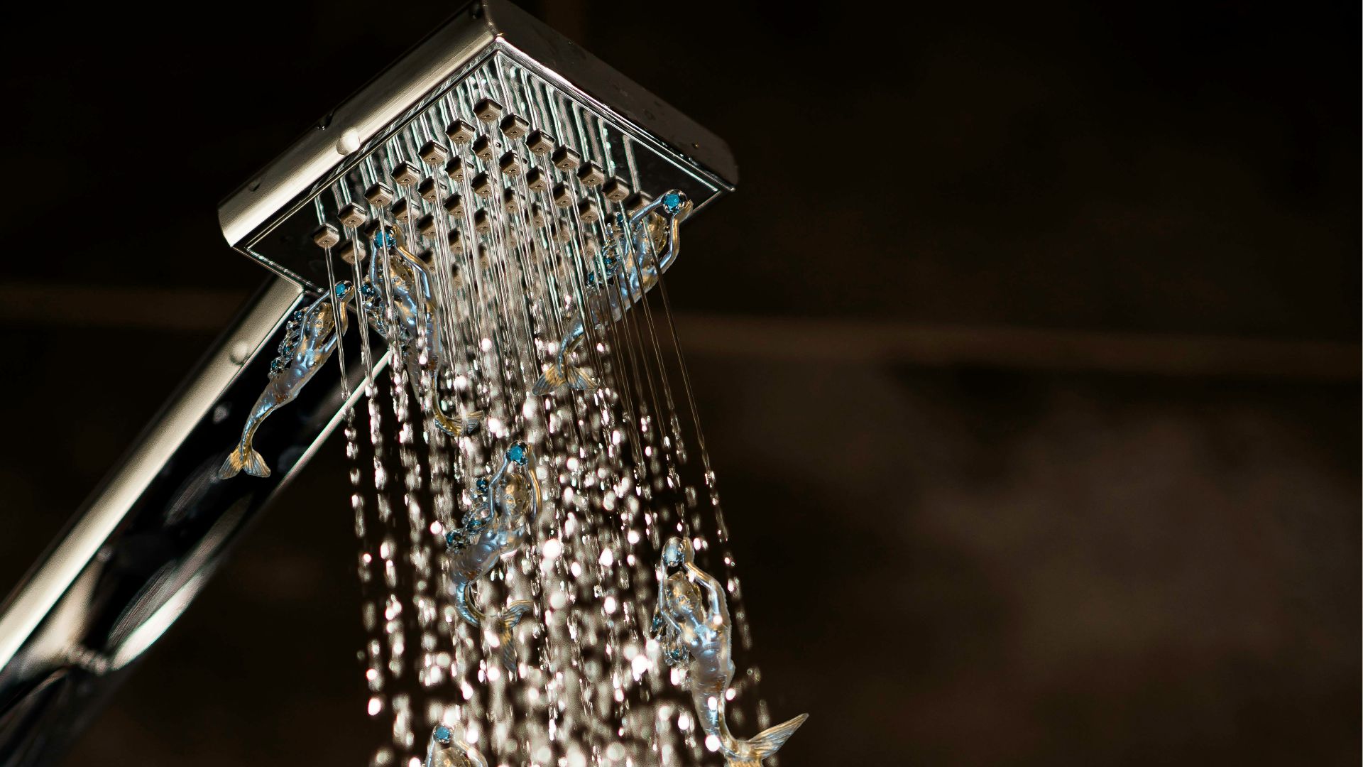 a close up of a shower head with water coming out of it