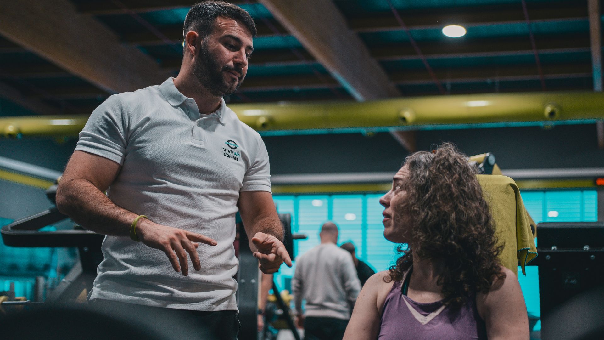 A man talking to a woman in a gym