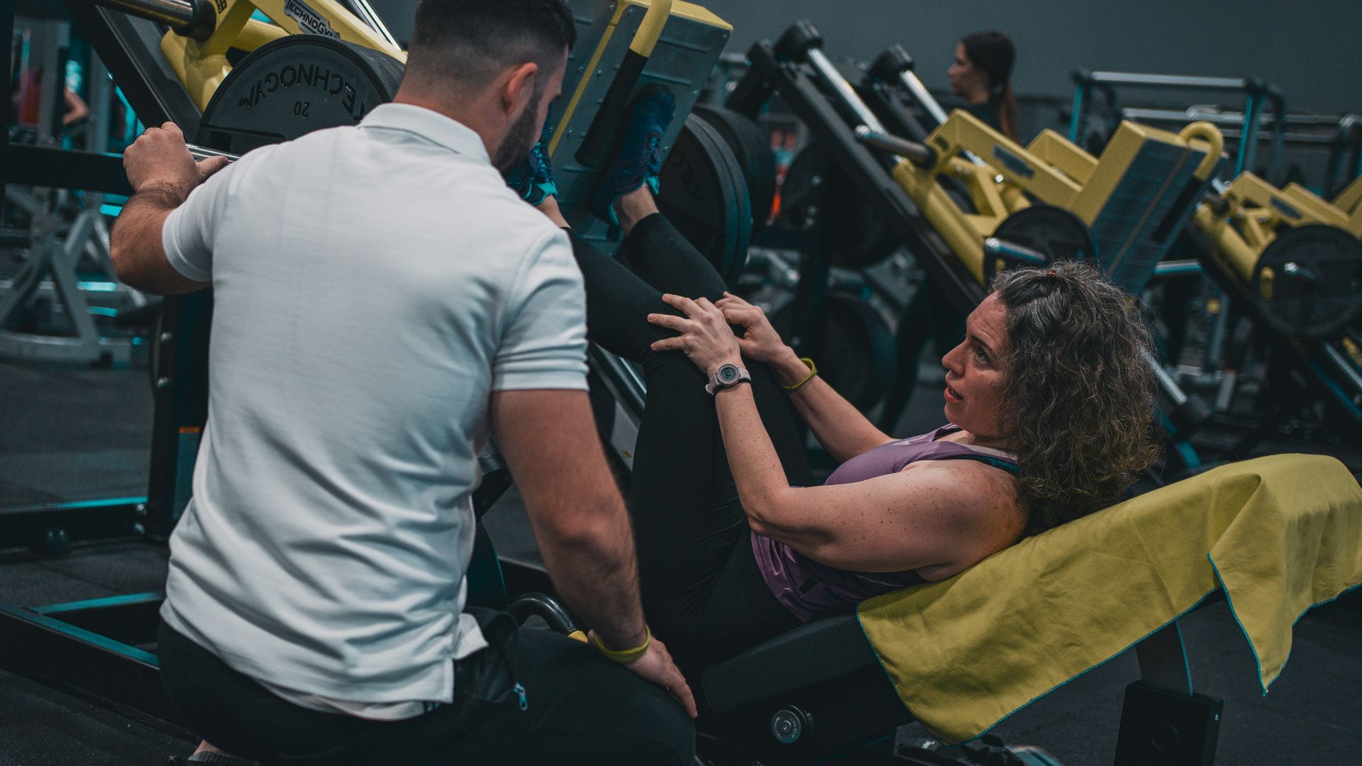 A man and a woman working out in a gym