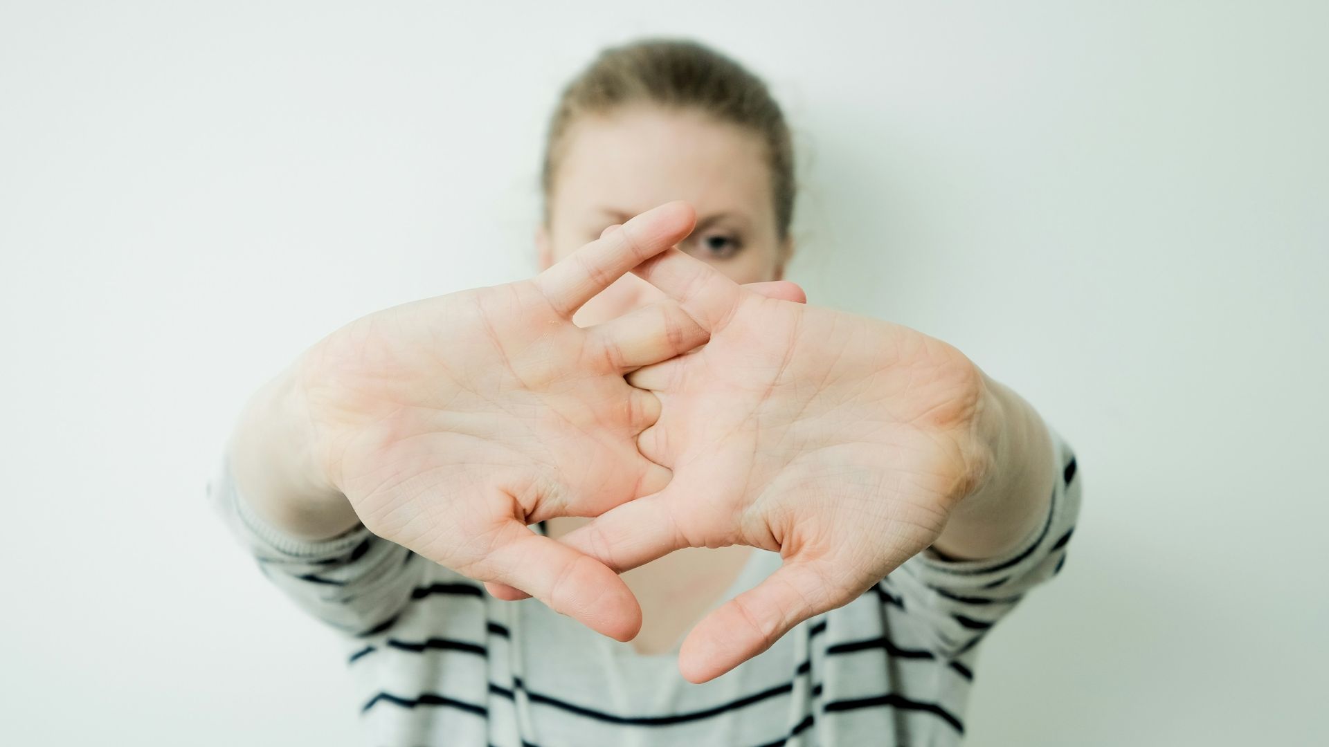 a woman making a heart with her hands