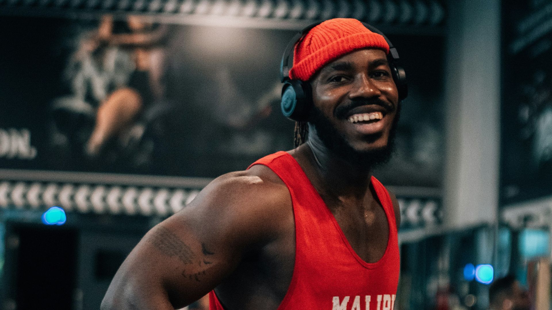 a man wearing a red shirt and headphones