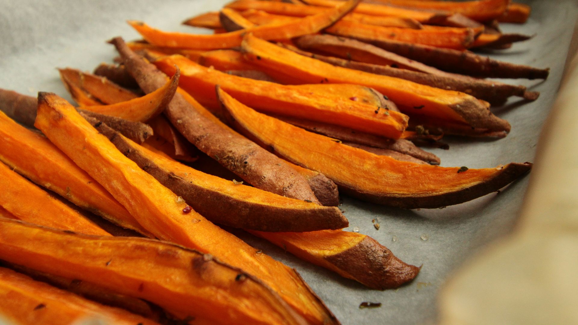 sliced orange fruit on white table