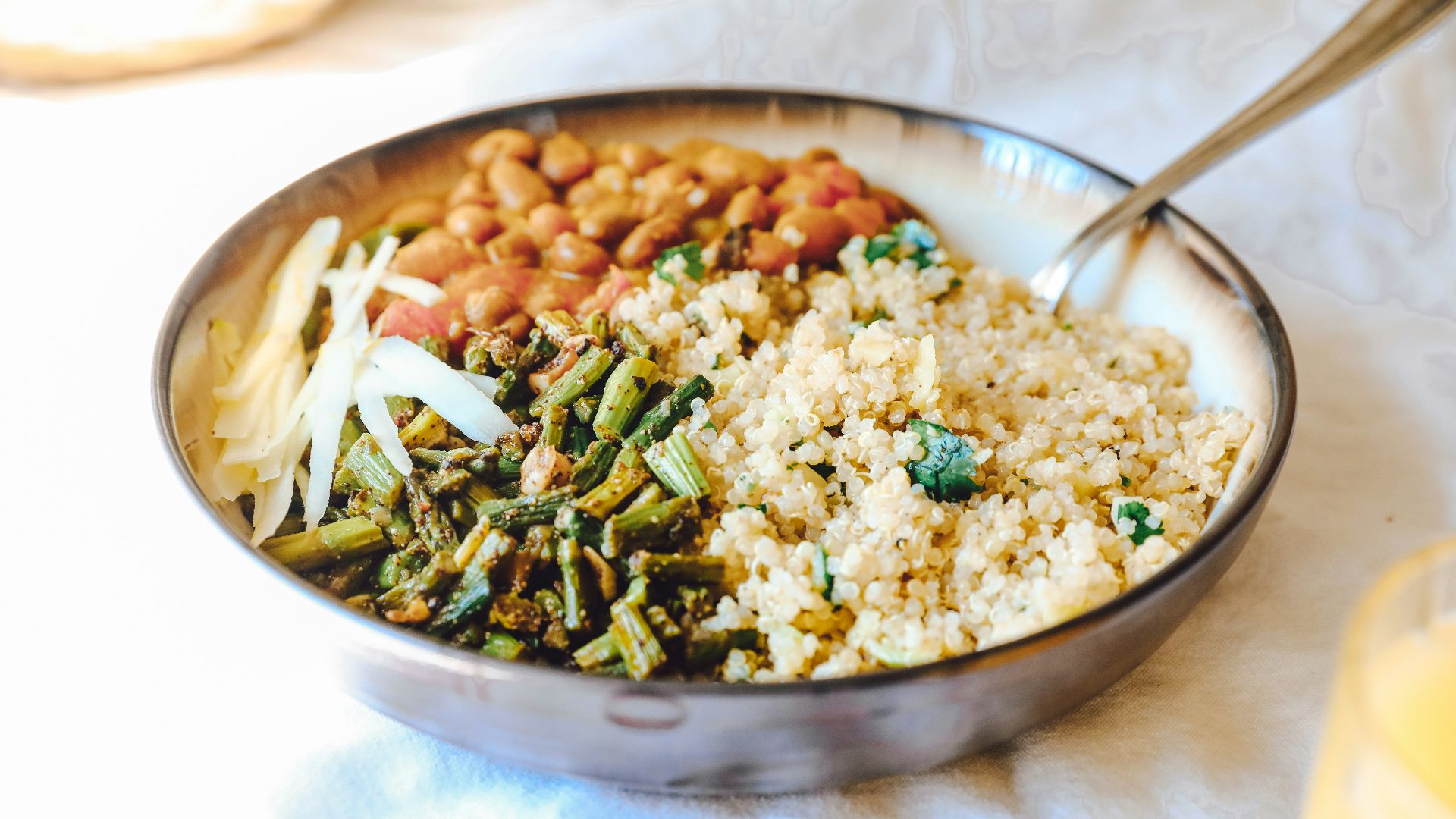 cooked rice with green peas and carrots on stainless steel bowl