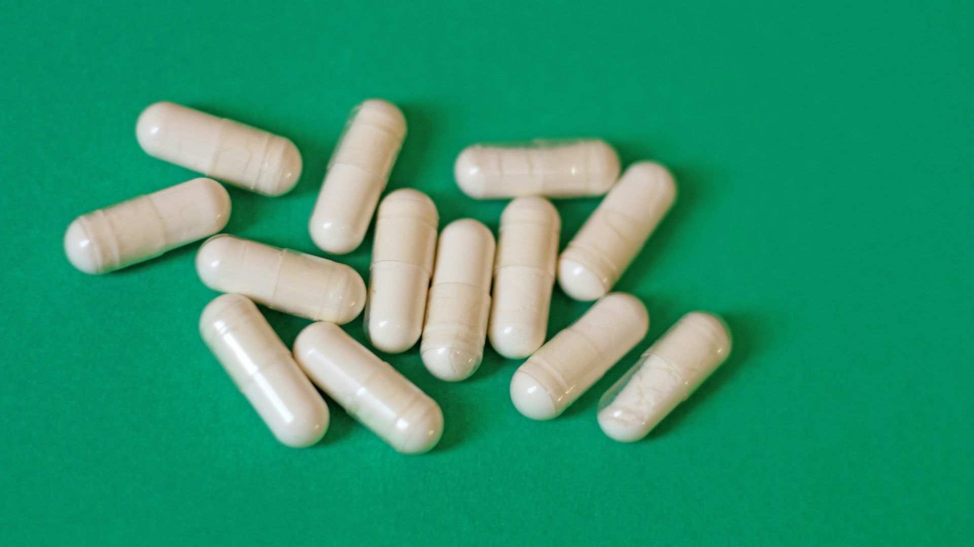 A pile of pills sitting on top of a green table