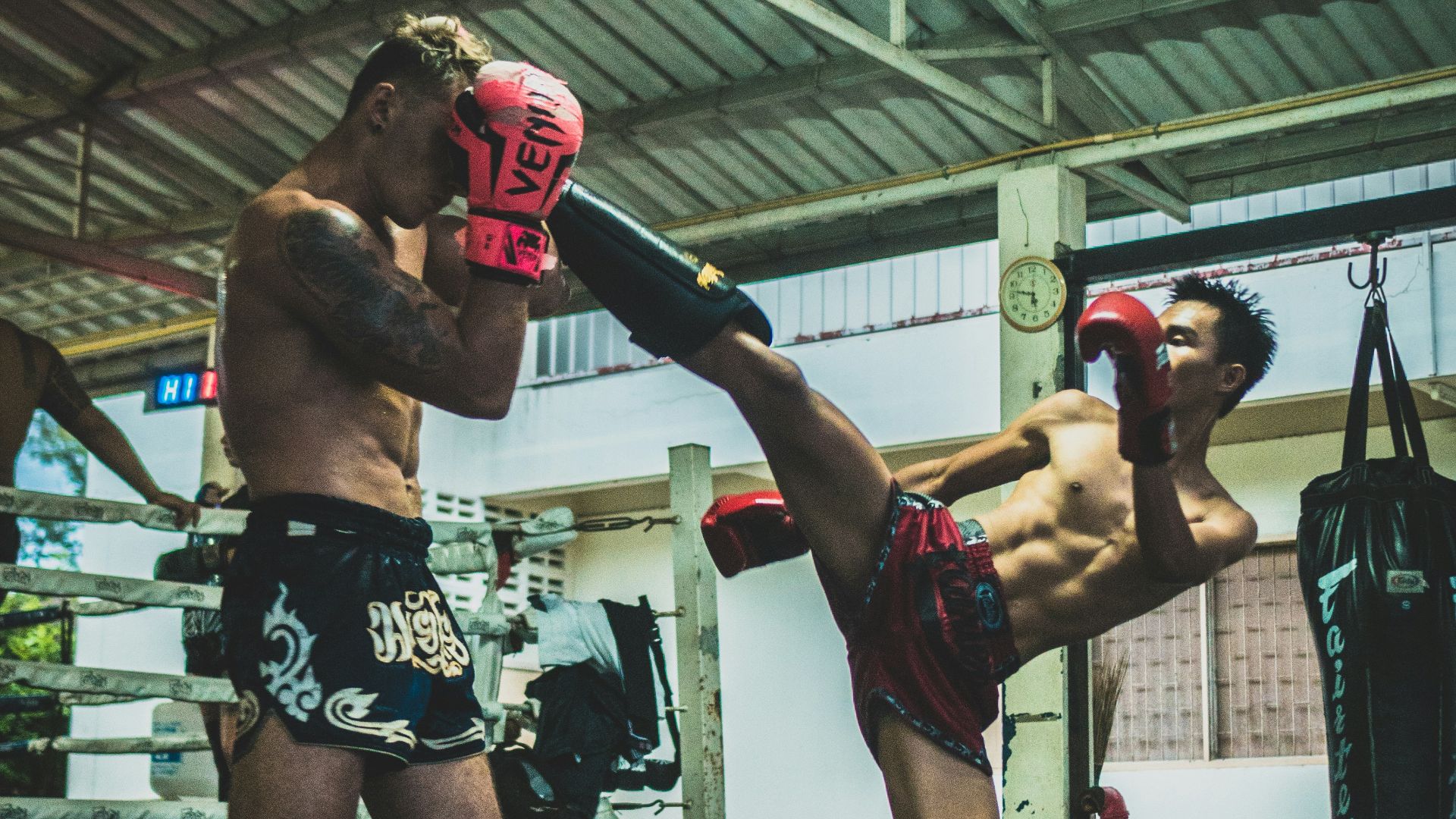 man kicking man's head