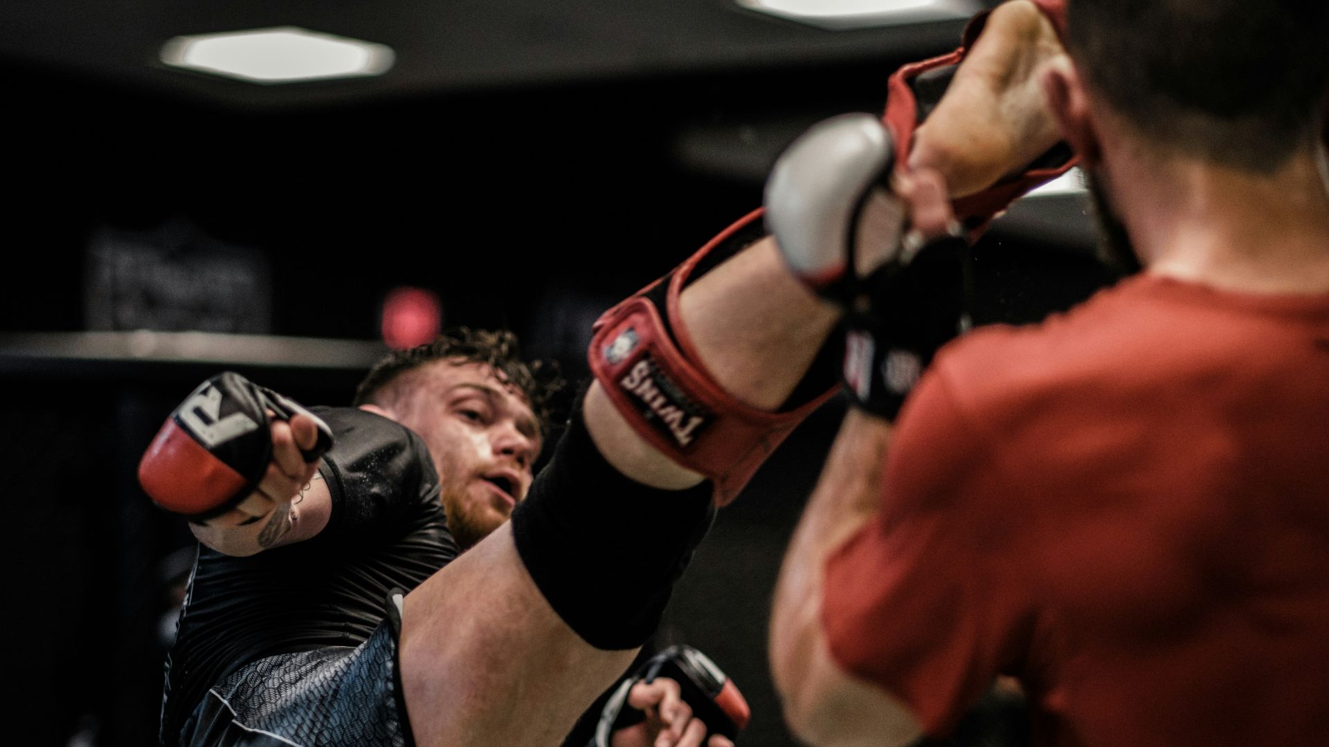 2 men in red and black boxing gloves