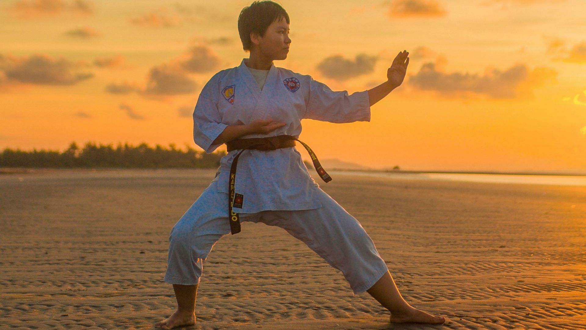 boy doing karate routines during golden hour