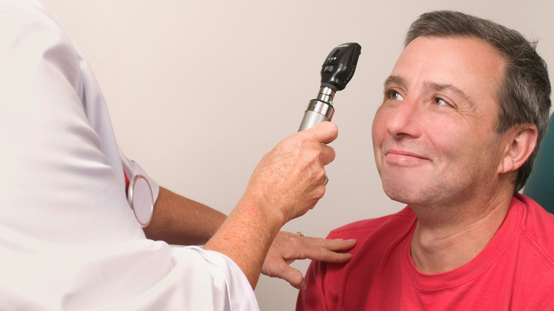 a man getting his teeth brushed by a doctor