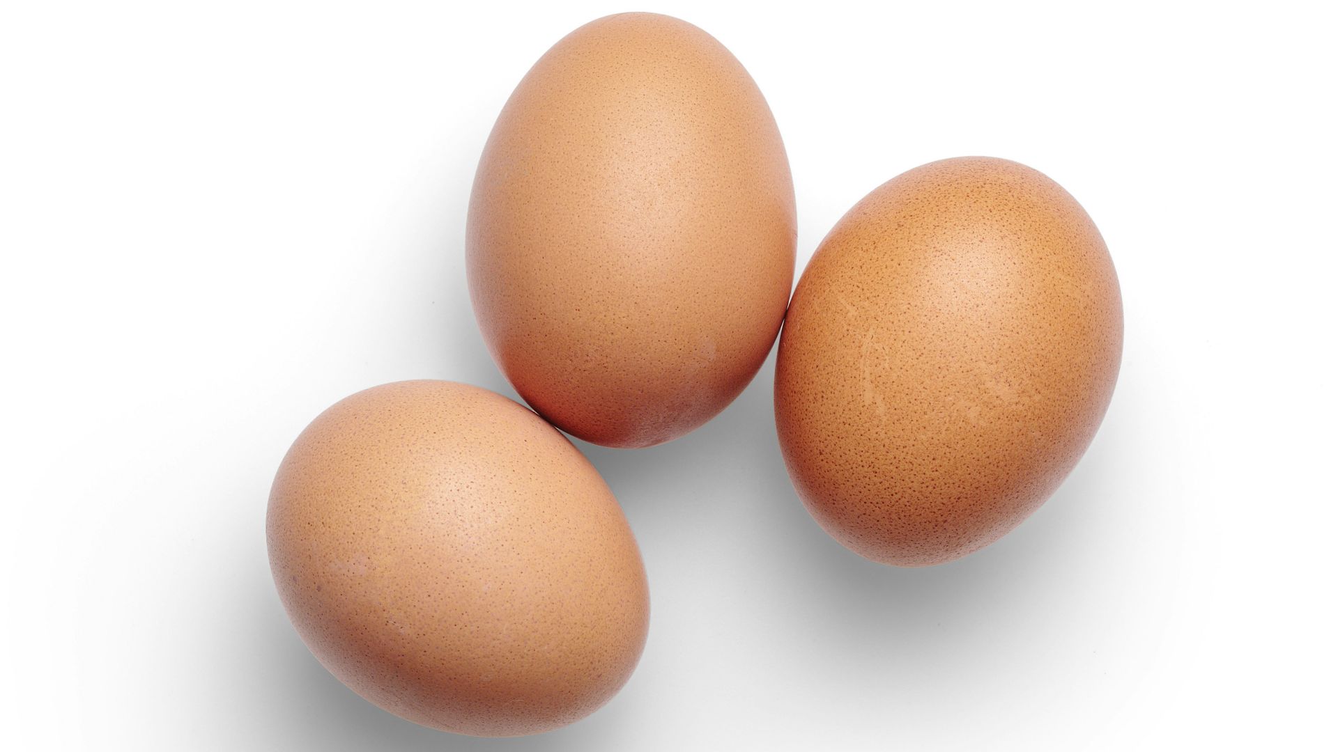 2 brown egg on white surface