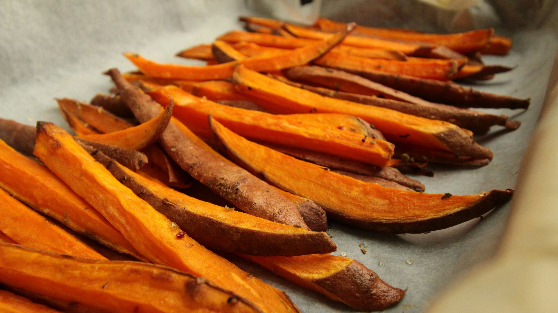 sliced orange fruit on white table