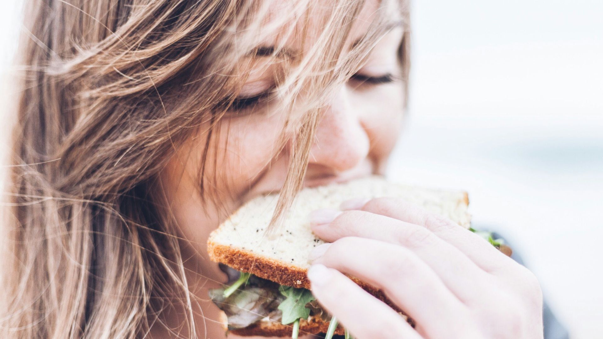 woman eating sandwich