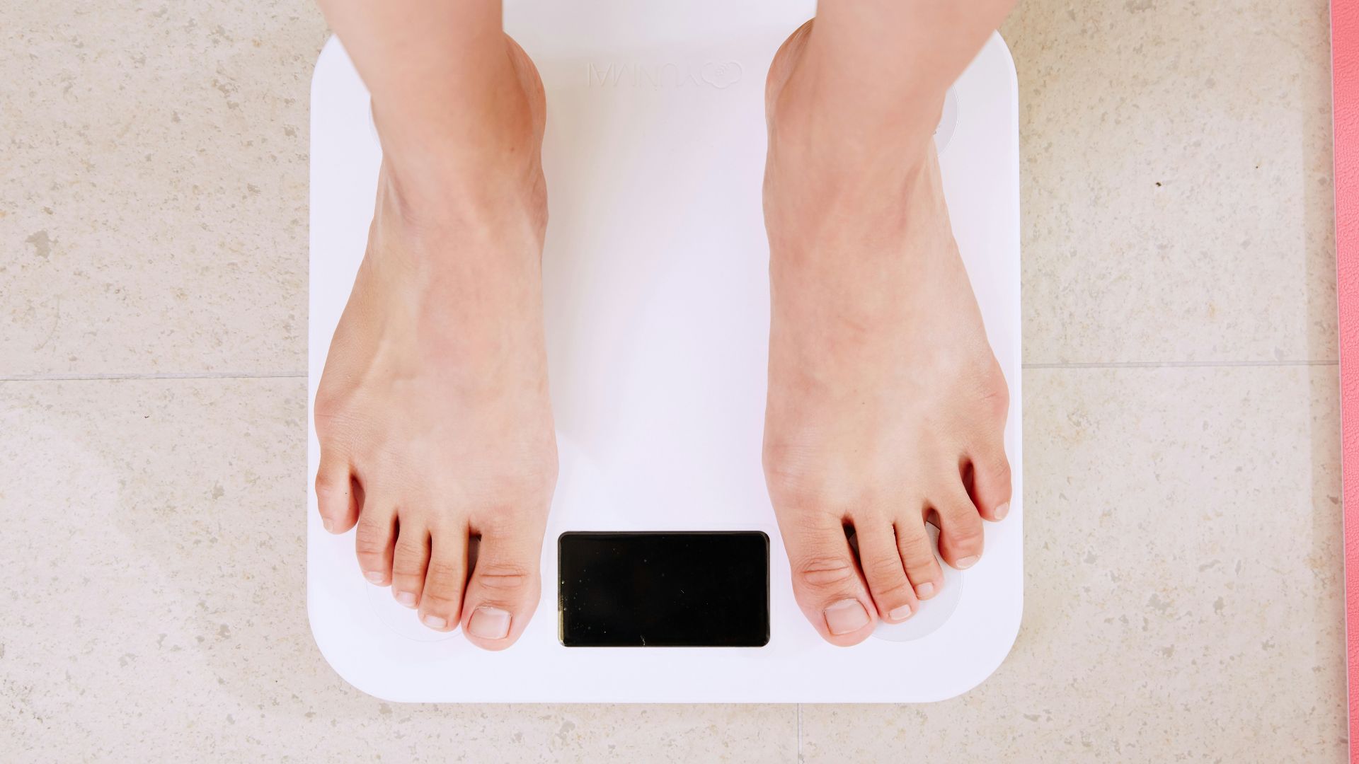 person standing on white digital bathroom scale